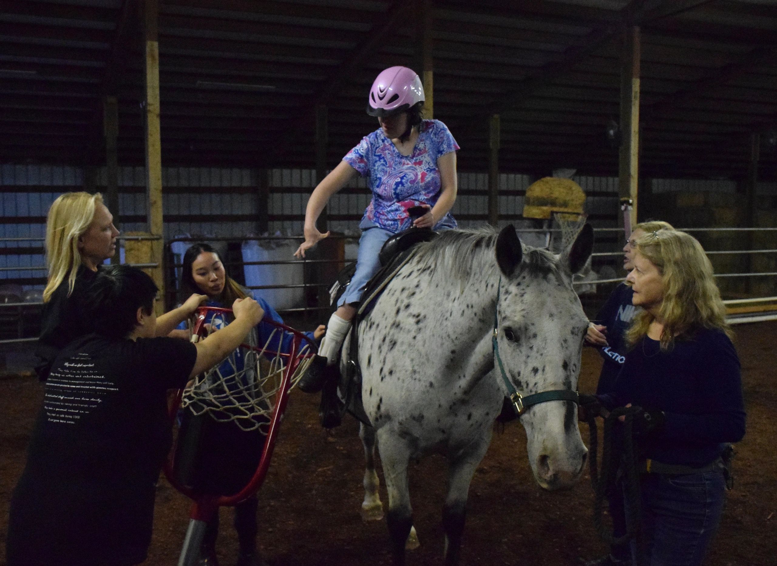 Therapeutic riding lesson with young rider and instructors