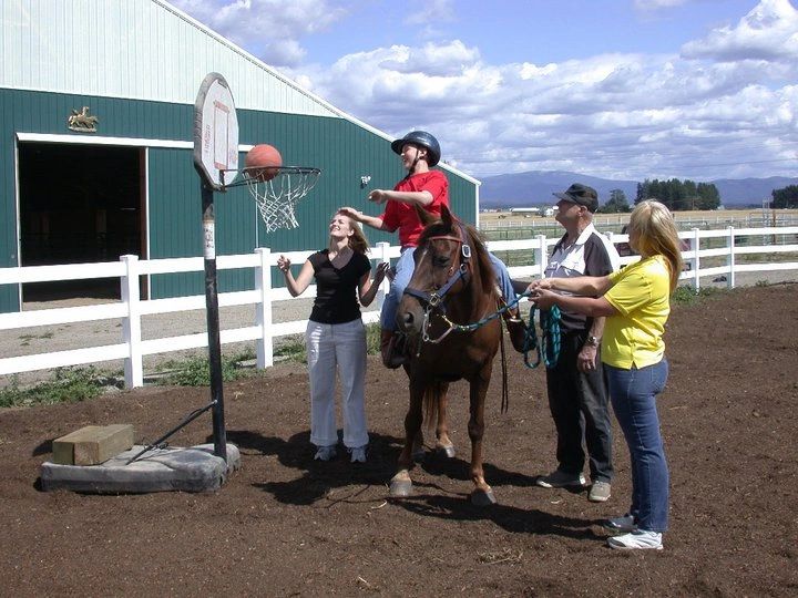 Children playing basketball on horseback at the ranch
